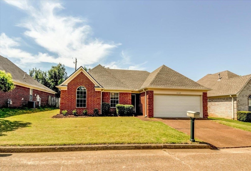 Brick exterior residence featuring a front-facing garage