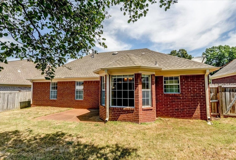 Brick exterior featuring multiple windows and a bay window