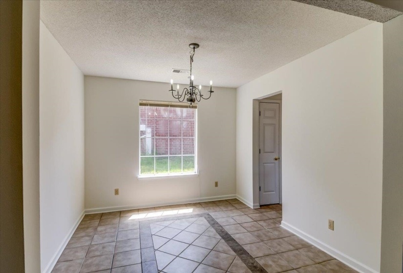 Room featuring tile flooring with a decorative border