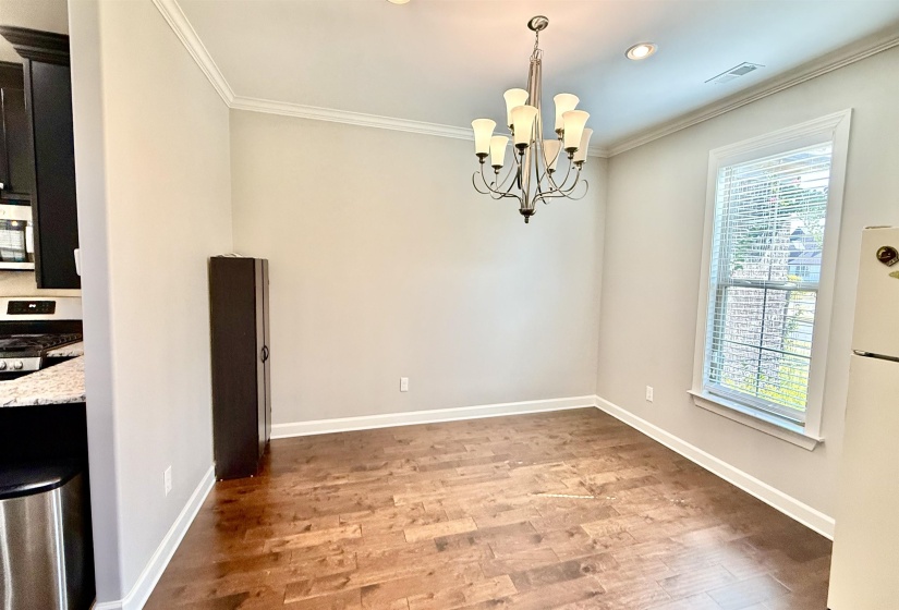 Unfurnished dining area with light wood-type flooring, crown molding, a chandelier, and recessed lighting