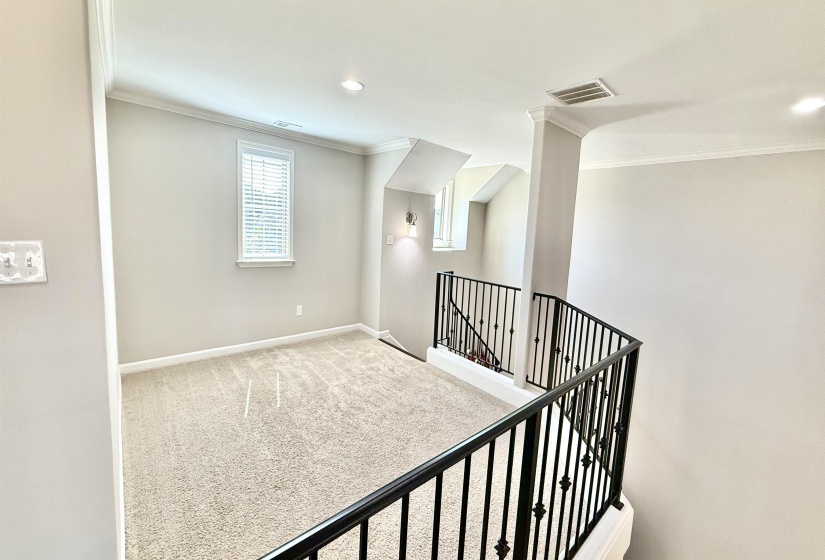 Hall with ornamental molding, carpet floors, an upstairs landing, and recessed lighting