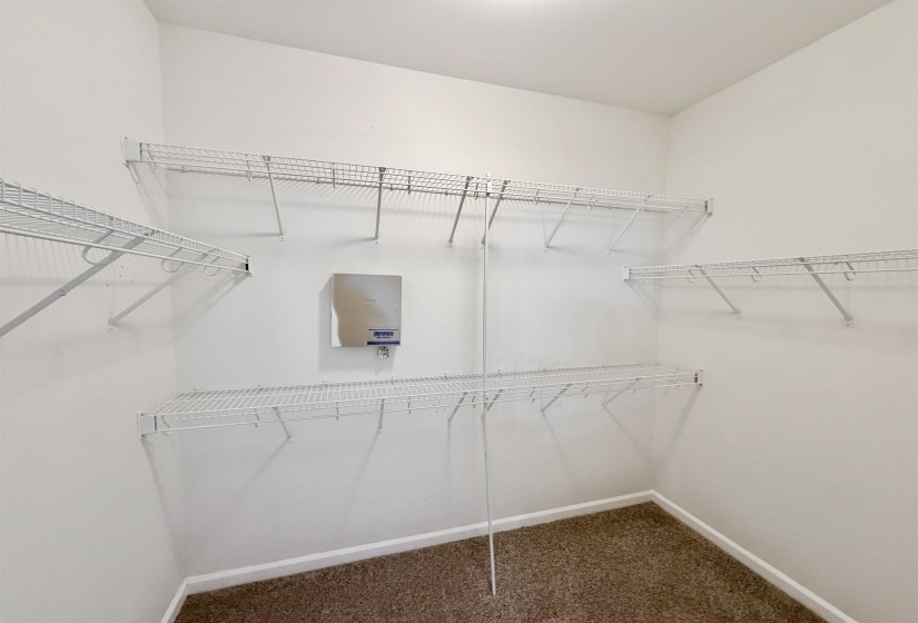 Walk-in closet featuring white wire shelving on multiple walls