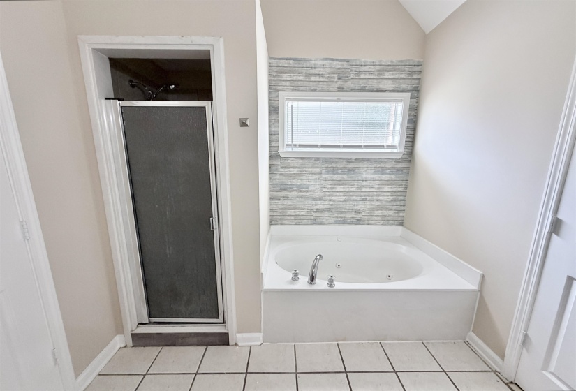 Corner soaking tub with integrated jets and chrome fixtures