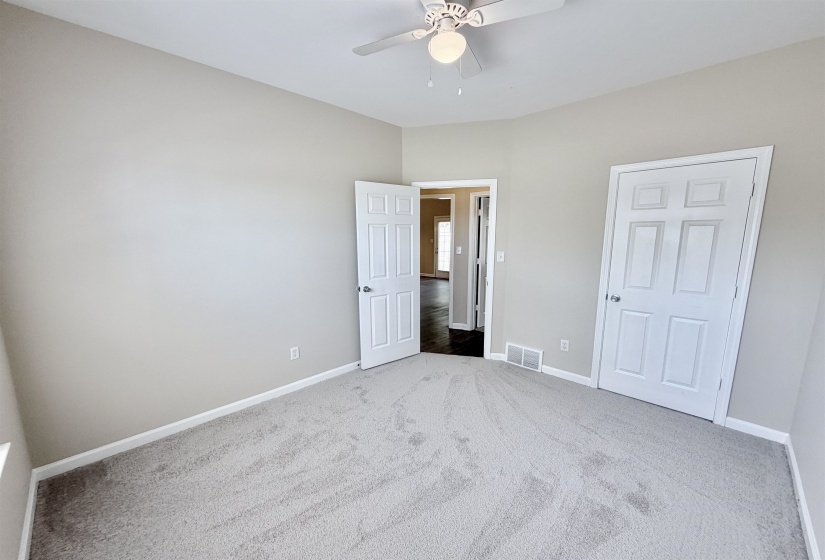Bedroom featuring light-toned carpeting and neutral wall paint