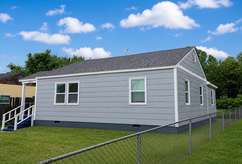 Light gray horizontal siding exterior with white trim accents
