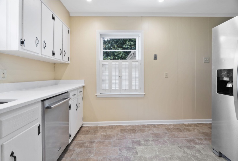 Kitchen featuring white cabinetry, new quartz countertops, and stainless steel appliances