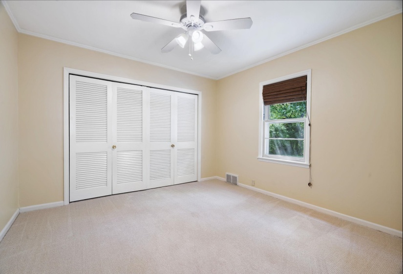 Windowed interior with neutral wall paint and light carpet flooring