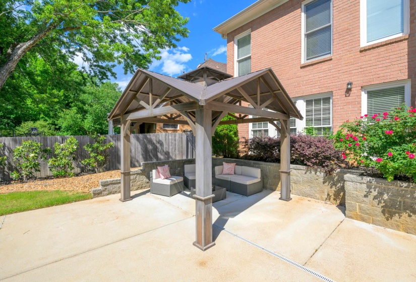 Covered patio featuring a wooden gazebo with a metal roof