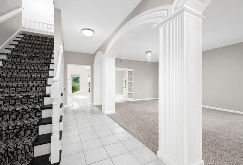 Beautiful 2 story Foyer featuring white tile flooring.