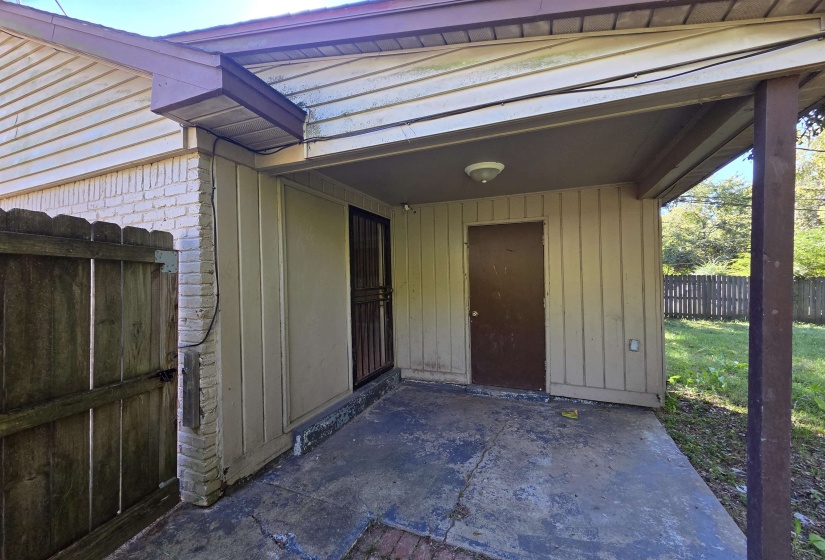 Doorway to property with a patio area