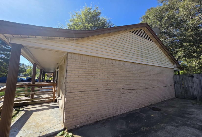 View of property exterior with brick siding