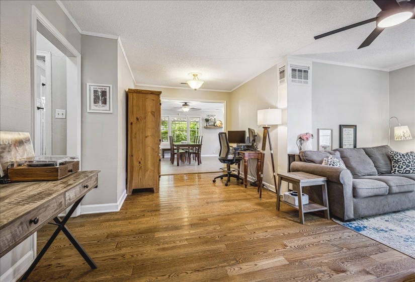 Expansive interior showcasing hardwood floors, and flex space, currently utilized as an office.