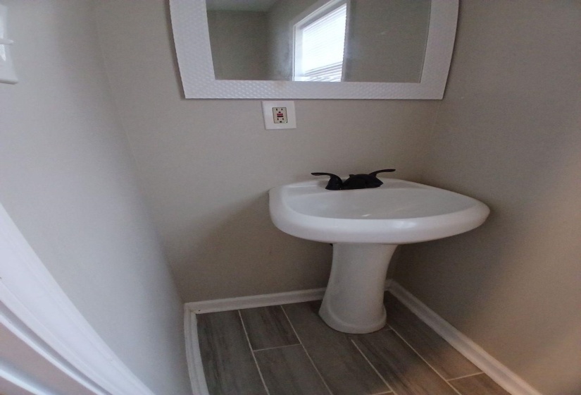 Pedestal sink with matte black faucet fixtures
