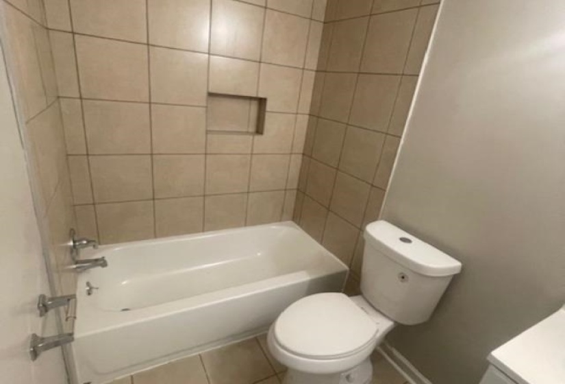 Full bath featuring shower / washtub combination, tile patterned flooring, and vanity