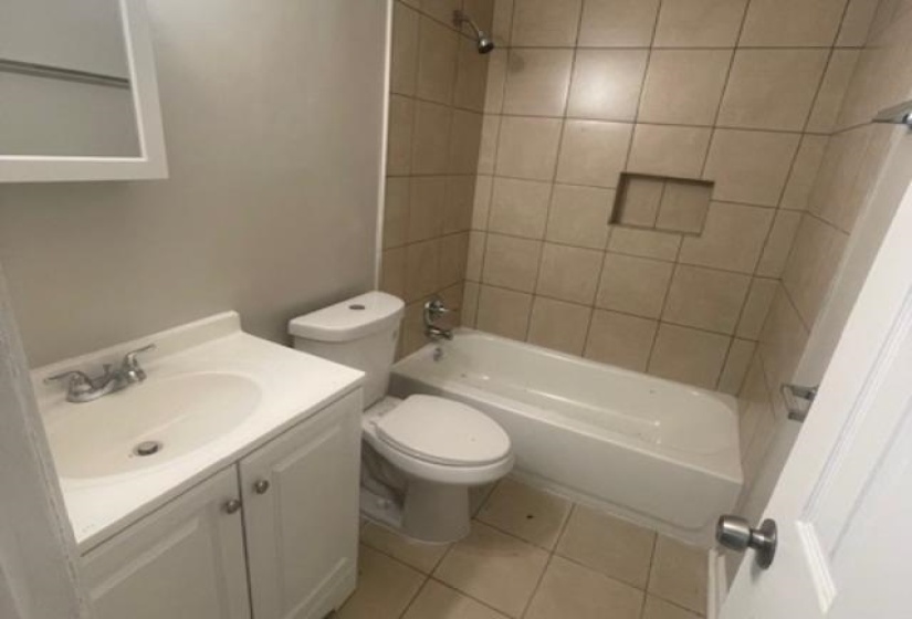 Full bathroom with shower / bath combination, vanity, and light tile patterned flooring