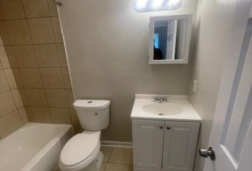 Full bathroom featuring vanity, light tile patterned floors, and bathtub / shower combination