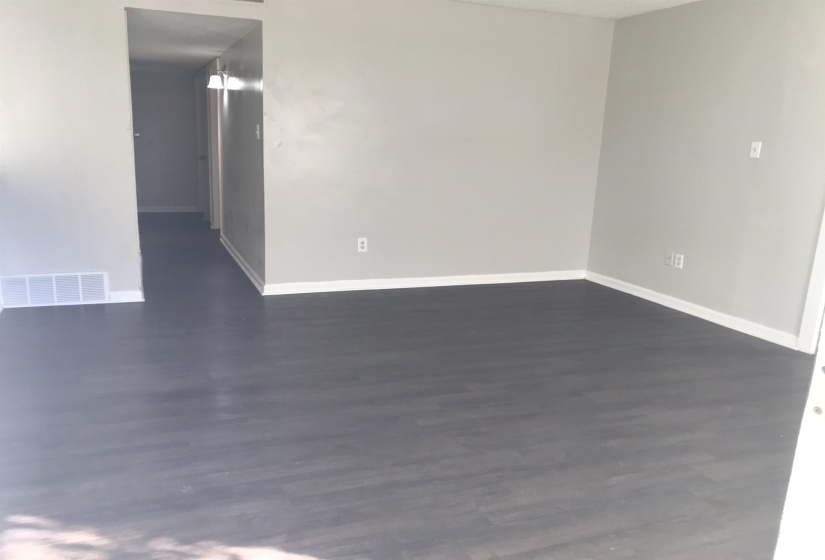 Spare room with dark wood-style flooring