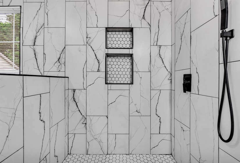 Bathroom view of a tile shower