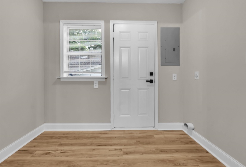 Entrance foyer featuring electric panel and light wood-style flooring