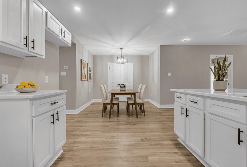 Dining room with light wood finished floors and suspended lighting