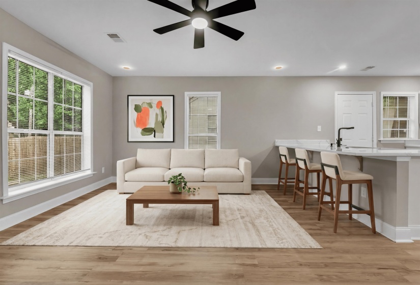 Living room with ceiling fan and light wood finished floors