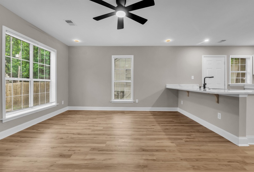 Interior space with a ceiling fan and light wood finished floors