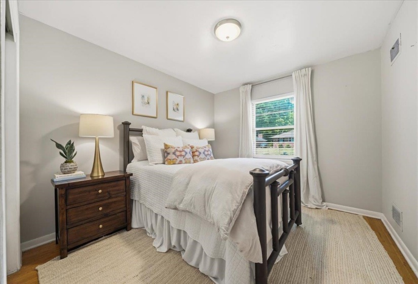 Interior room featuring light gray walls and wood-finish flooring