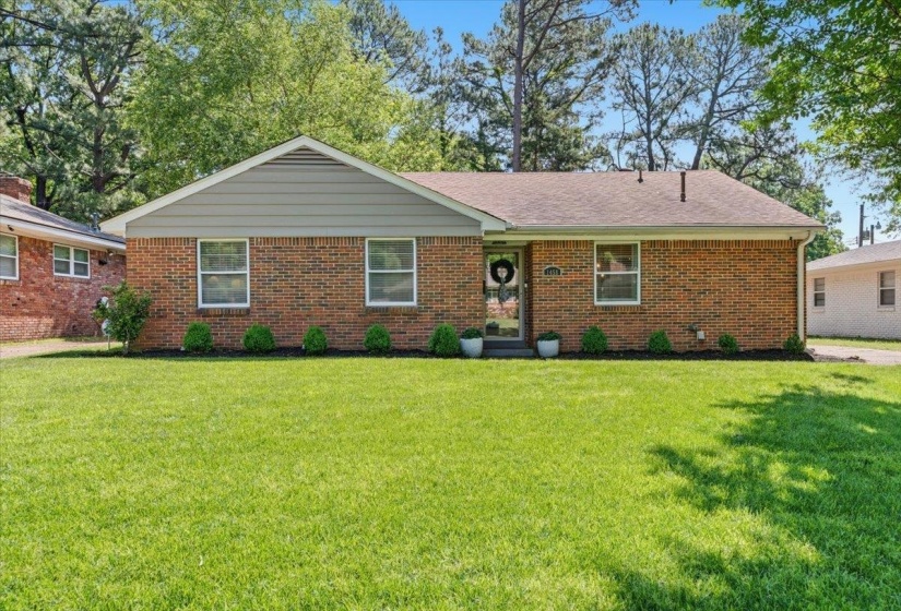 Brick exterior with light gray siding and a brown shingle roof