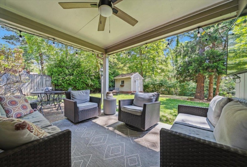 Covered patio with a ceiling fan, string lights, and a concrete surface