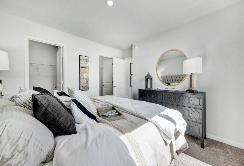 Bedroom featuring carpet floors and a spacious closet