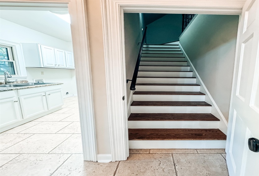 Hardwood treads with white risers and a black handrail