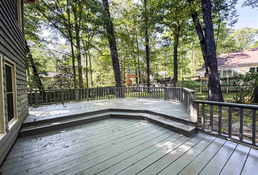 Expansive wooden deck with a multi-level design and a full perimeter railing