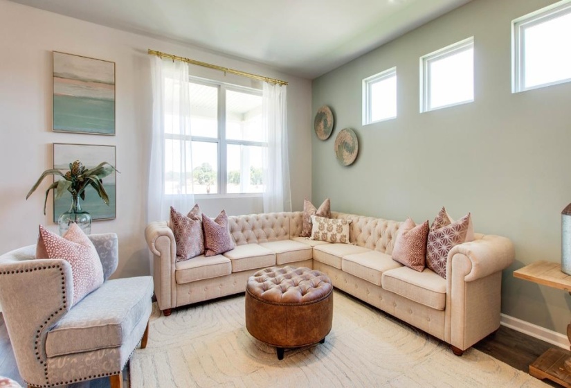 Living area featuring multiple windows, recessed lighting, and wood-finish flooring