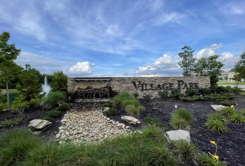 Stone entry monument featuring a cascading water feature and stacked stone construction