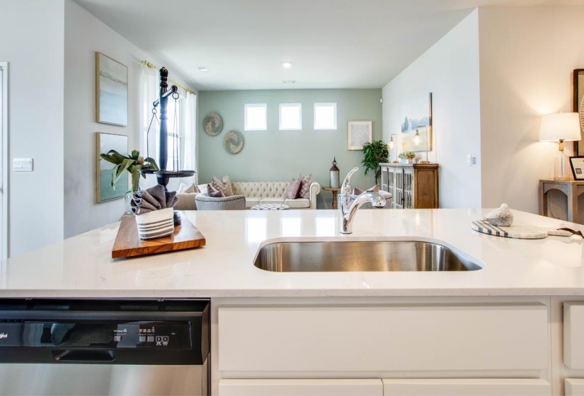 Kitchen island featuring a stainless steel undermount sink and chrome faucet