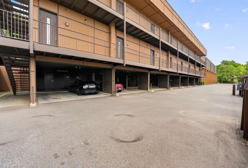 Multi-story building exterior featuring light brown siding and dark brown trim
