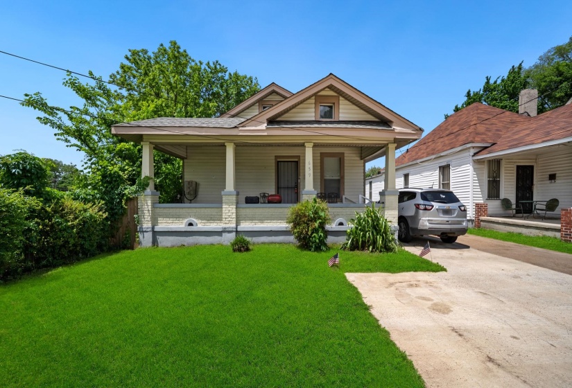 Craftsman-style home featuring a covered front porch with substantial columns, a pitched roofline, and dormer window