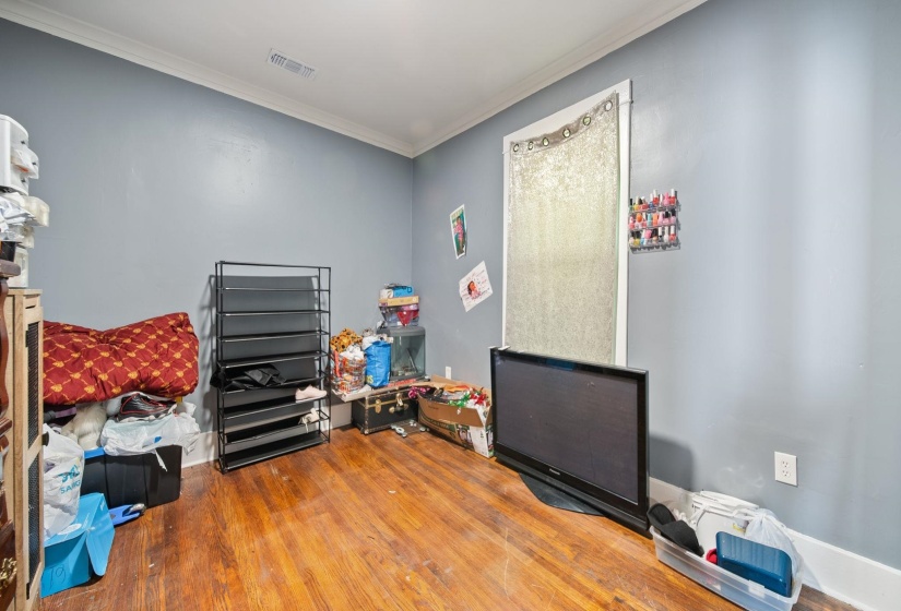 Interior room featuring wood-finish flooring and light blue walls