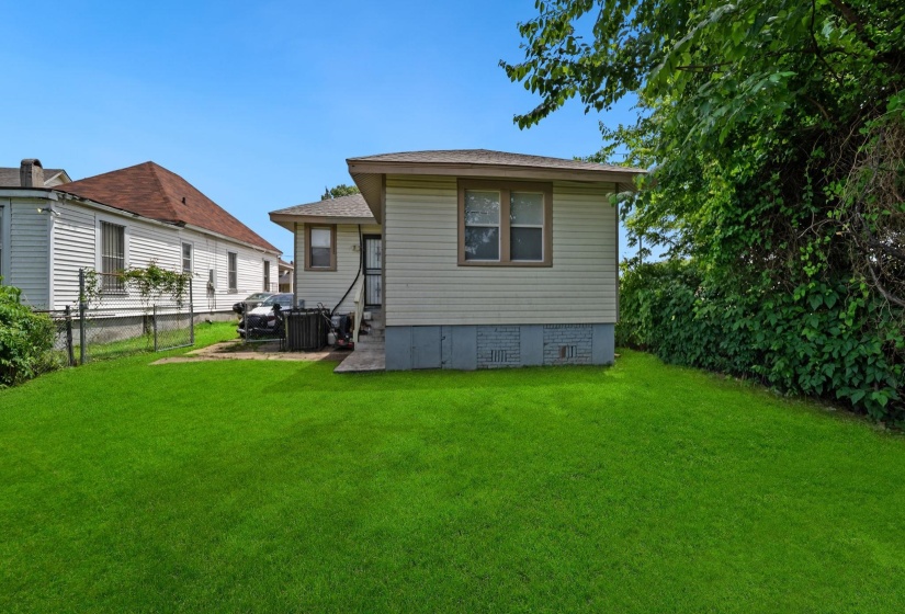 Expansive green lawn with rear property access