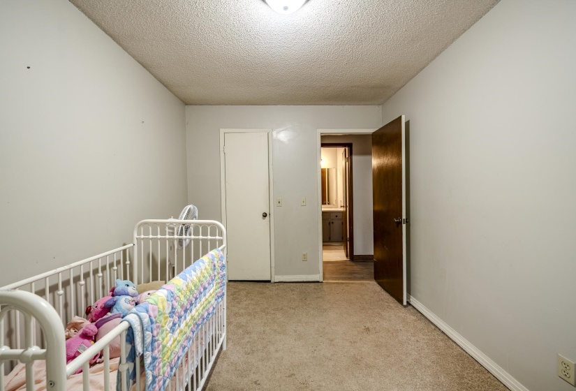 Carpeted room with light-toned walls and a textured ceiling