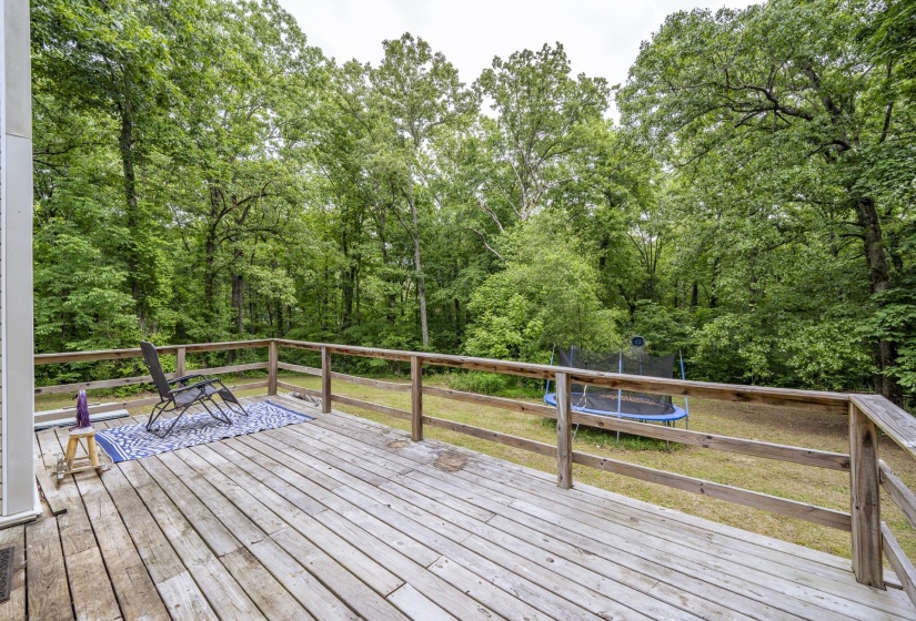 Spacious wood deck with a natural wood railing