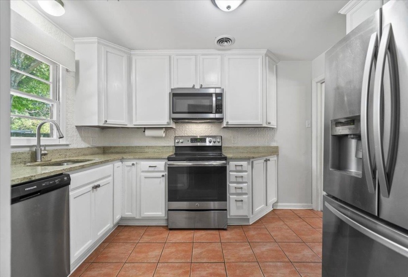 Renovated kitchen with granite counter tops and cabinets that go all the way to the ceiling.