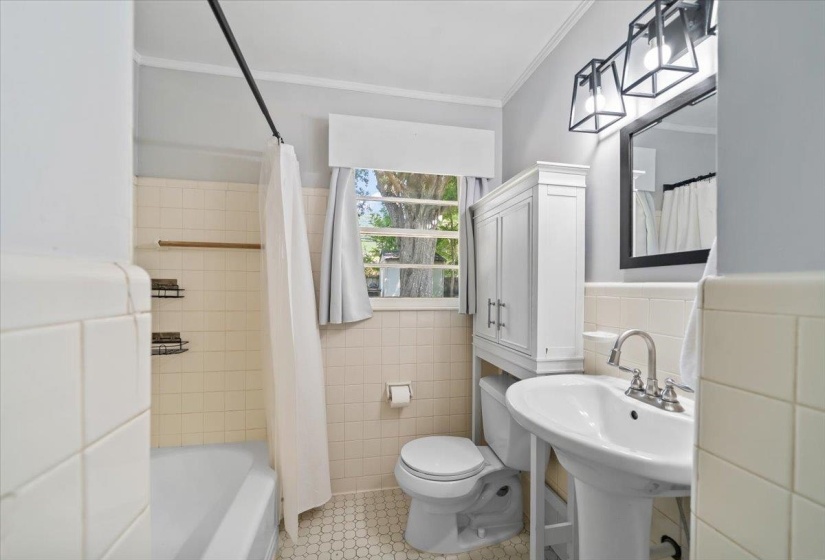 Super cute bathroom with new paint and new light fixture.