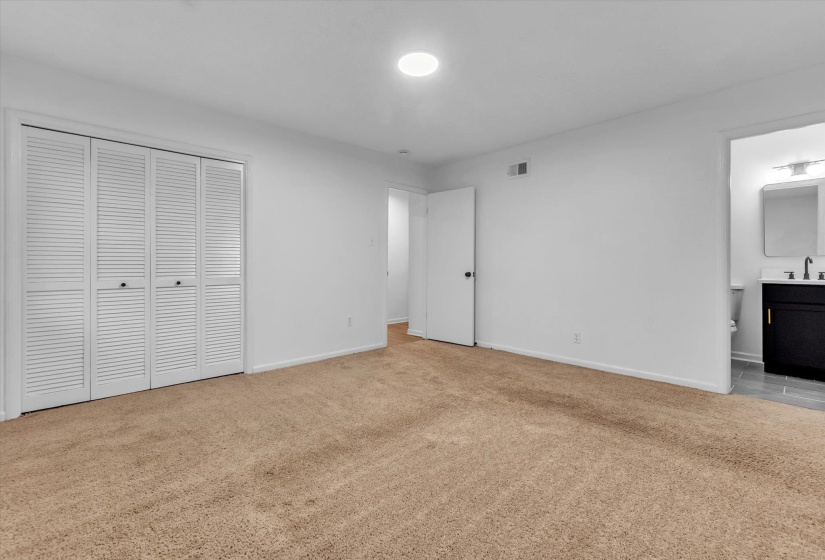 Neutral wall color and carpeted flooring