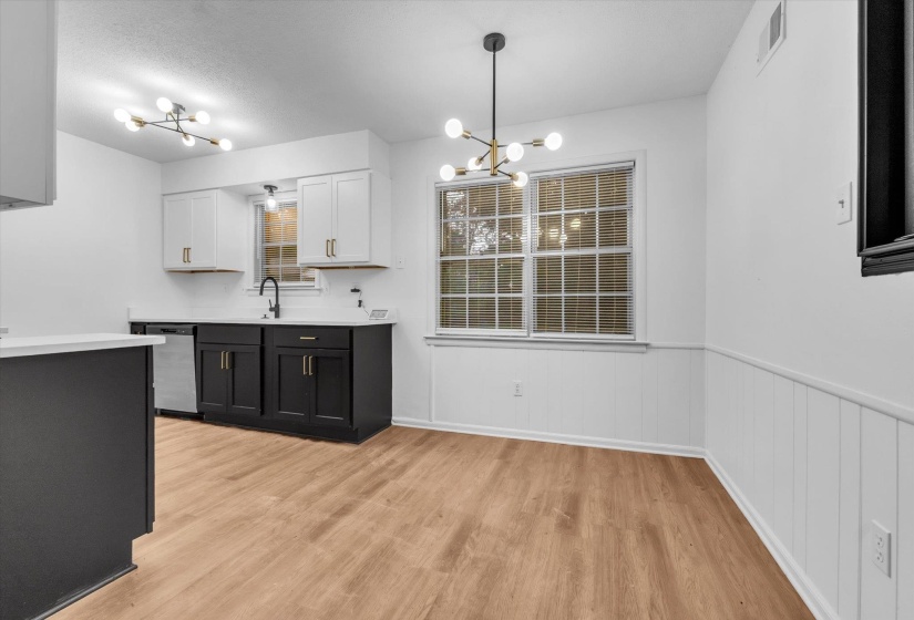 Kitchen and dining area featuring wood-finish flooring