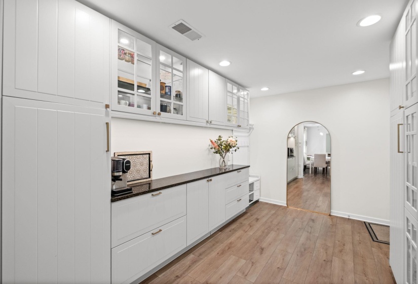 15x10 renovated space off of the kitchen that could be used as a sitting/living space, home office, dining area, expansion of kitchen, large laundry room, or whatever you desire!