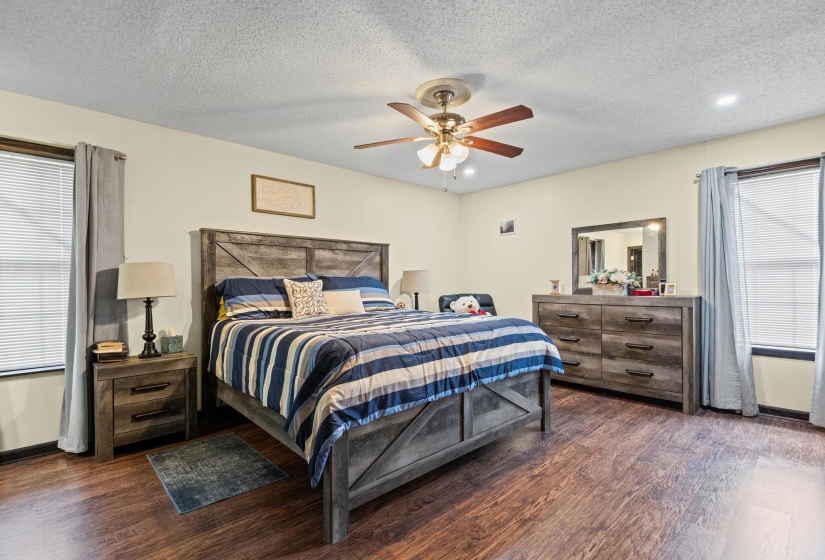 Spacious room featuring wood-finish flooring and light-toned walls
