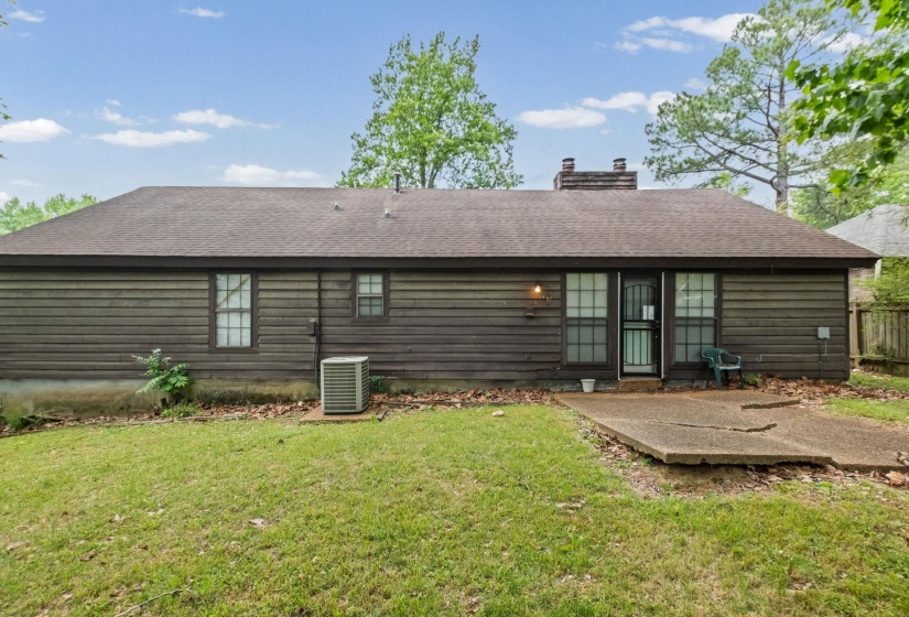 Rear exterior featuring horizontal wood siding and a pitched shingle roof