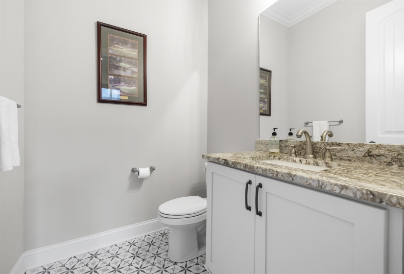 Bathroom featuring a white vanity with dark hardware, a stone countertop, and a brushed nickel faucet