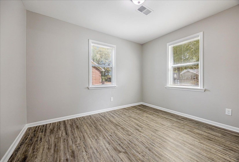 Empty room featuring wood finished floors and baseboards